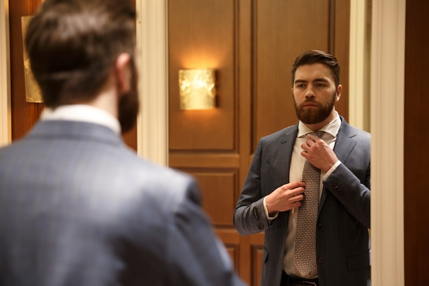 View from back of young man looking at the mirror