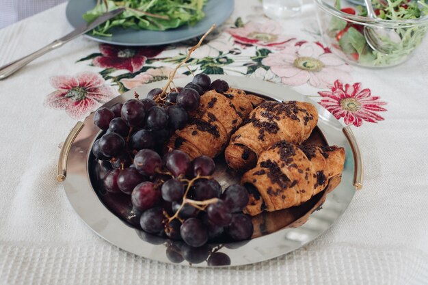 View from above of delicious chocolate croissants and grape