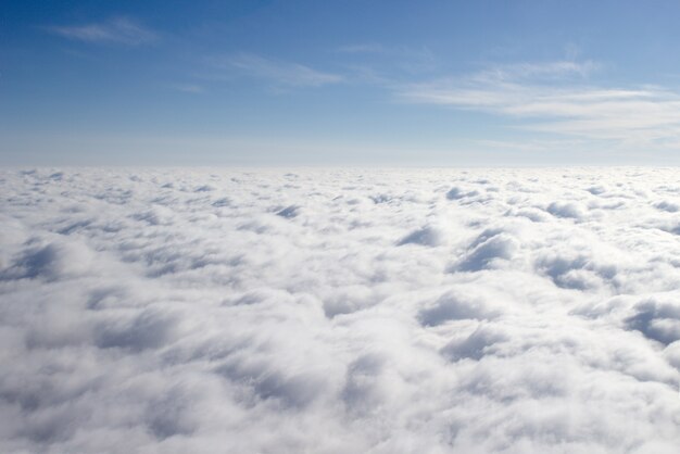 View from a plane on a closed cloud cover, a third of sky