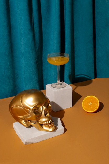 View of golden skull with citrus cocktail