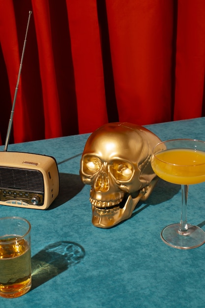 Free photo view of golden skull with citrus cocktail