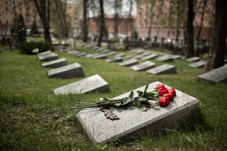 Free Photo view of gravestone with flowers