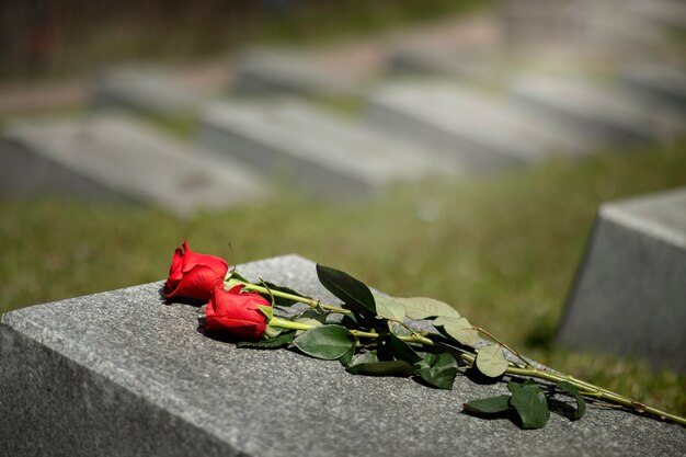 View of gravestone with flowers