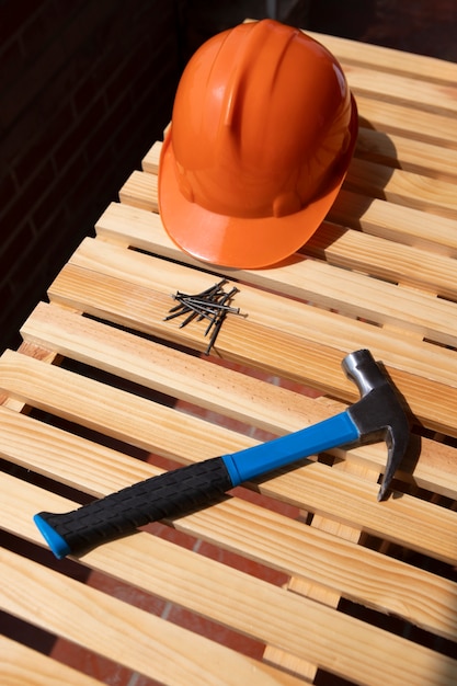 Free photo view of hammer with hard hat for construction