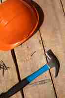 Free photo view of hammer with hard hat for construction