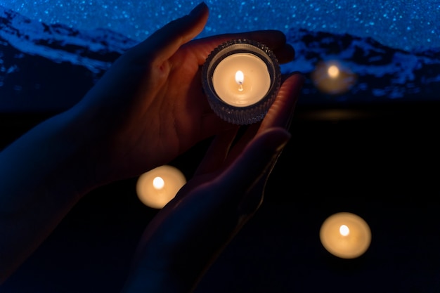 Free photo view of hands holding candles