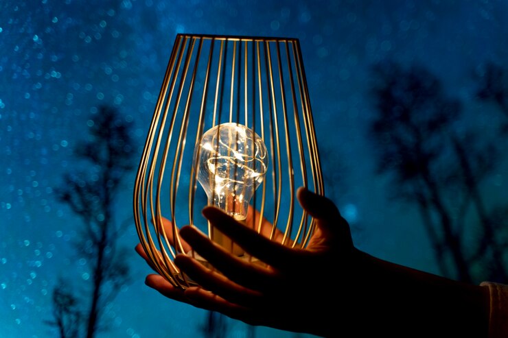 Free Photo view of hands holding lightbulb lamp