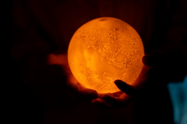 Free photo view of hands holding moon light