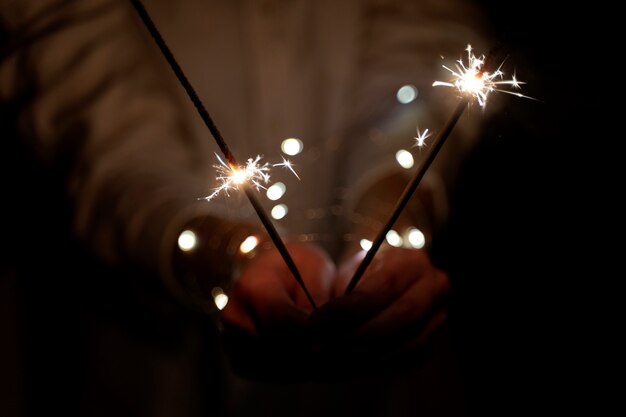 View of hands holding sparkles