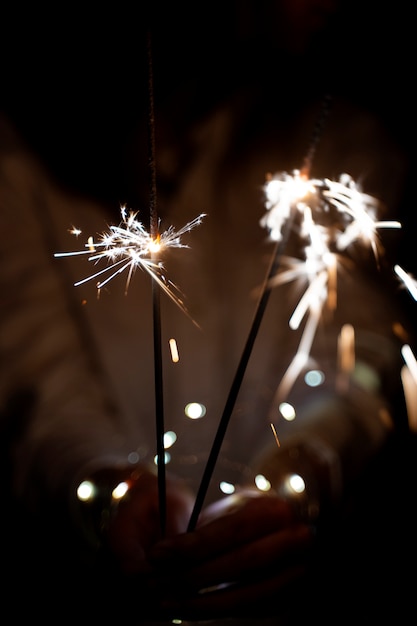 Free photo view of hands holding sparkles