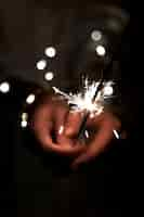 Free photo view of hands holding sparkles