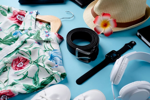 View of hawaiian shirt with floral print on hanger and belt