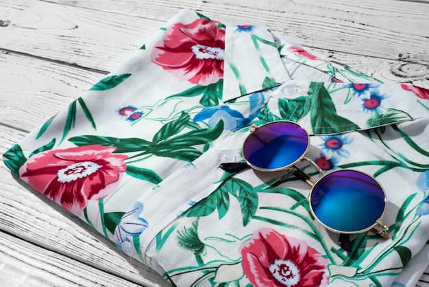 View of hawaiian shirt with floral print and sunglasses