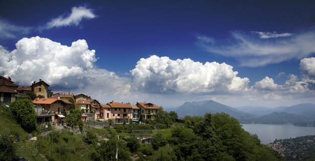 View of houses on top of a mountain with a view of a sea surrounded by mountains