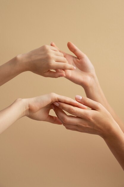 View of human hands against colored background