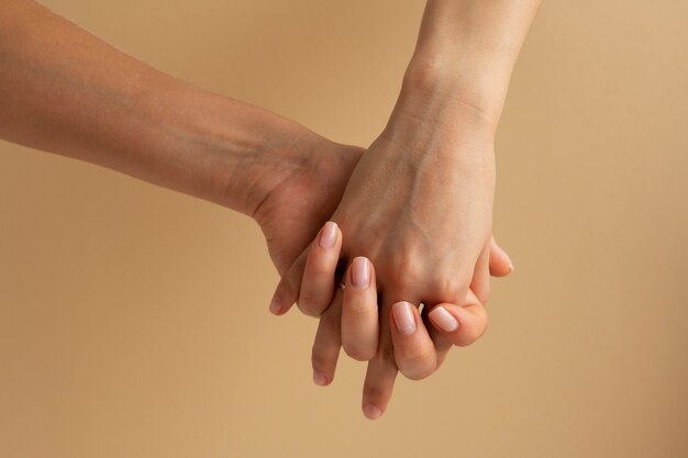 View of human hands against colored background