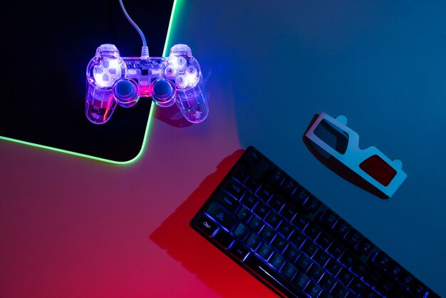 View of illuminated neon gaming keyboard setup and controller