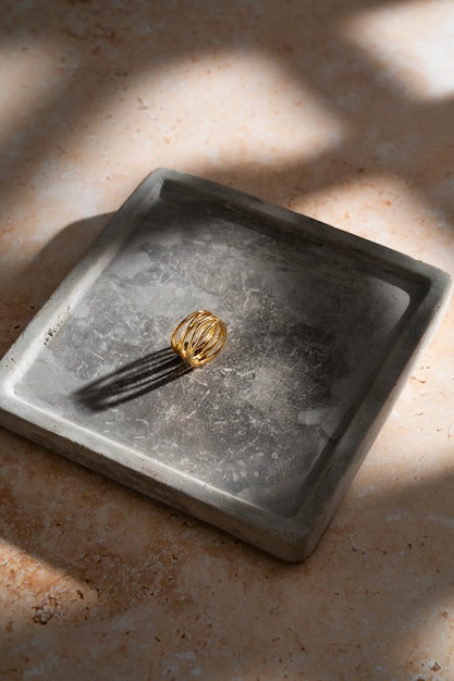 Free photo view of luxurious golden ring on rock or concrete tray