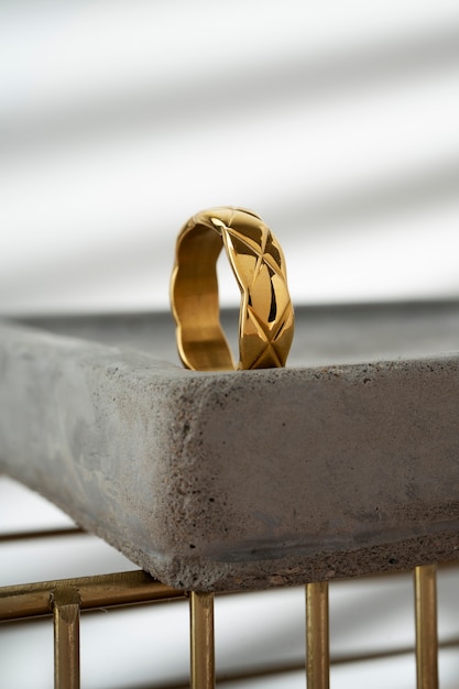 Free photo view of luxurious golden ring on rock or concrete tray