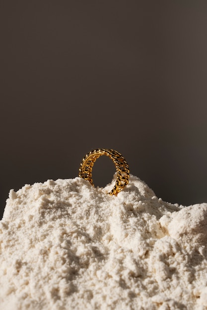 View of luxurious golden ring with white dust