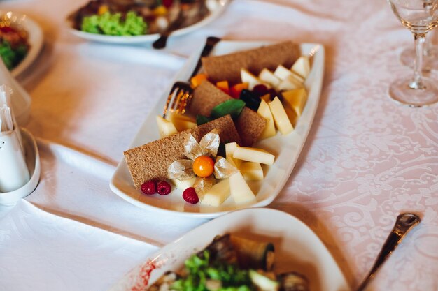 View of many round plates with tasty vegetables dish of salads with tomato onion zucchini tomato and herbs Big delicious for dinner in restaurant