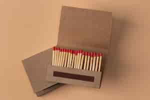 Free photo view of matchbox with wooden matchstiks