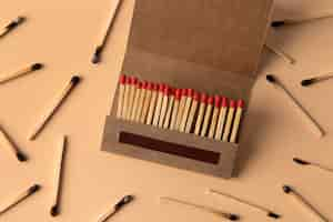 Free photo view of matchbox with wooden matchstiks