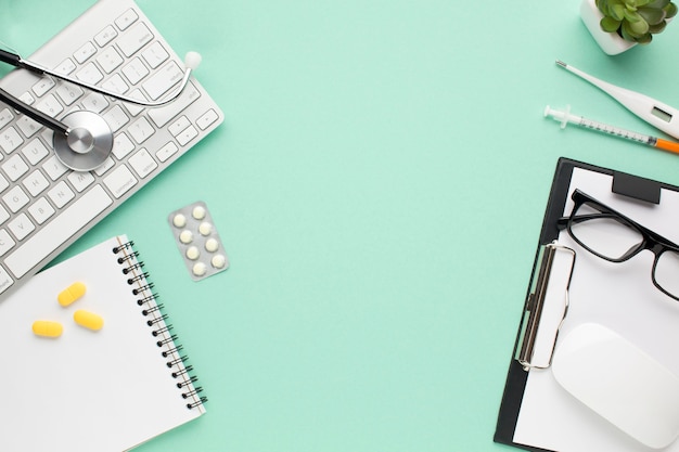 View of medical accessories and pills and small plant on doctor's desk