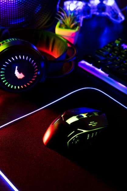 View of neon illuminated gaming desk setup with keyboard