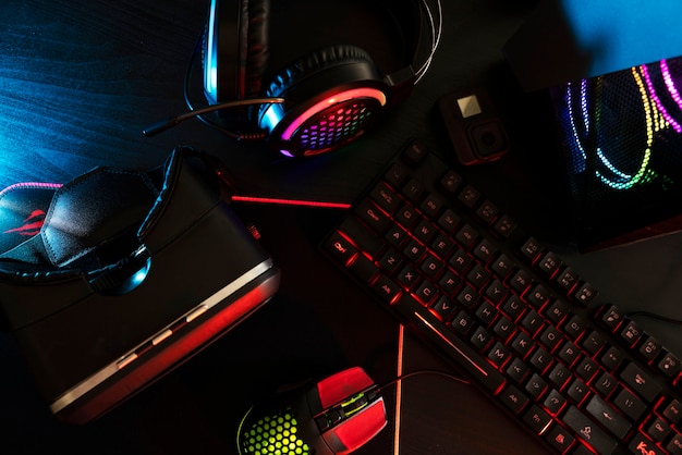 View of neon illuminated gaming desk setup with keyboard