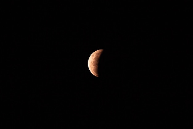 View of the partial lunar eclipse in the dark sky