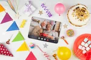 Free photo above view party decorations and tablet