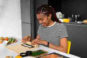 Free photo view of people learning how to make traditional sushi dish