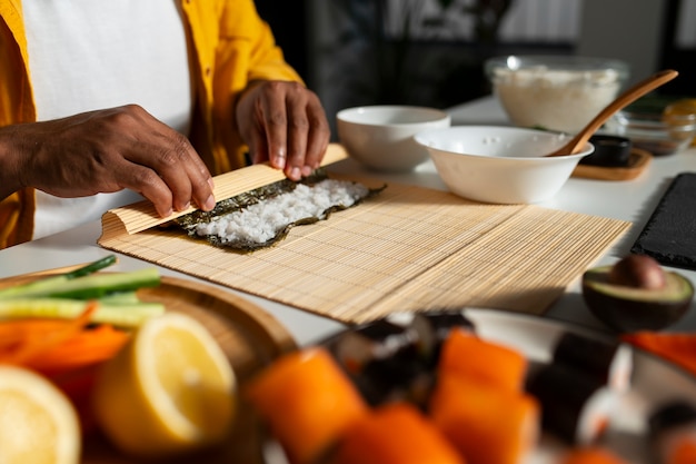 Free photo view of people learning how to make traditional sushi dish