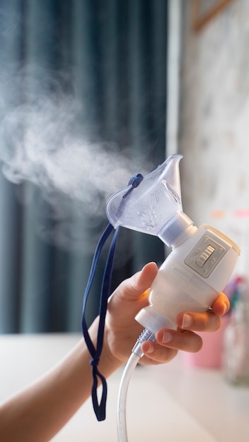 View of person holding nebulizer in hand