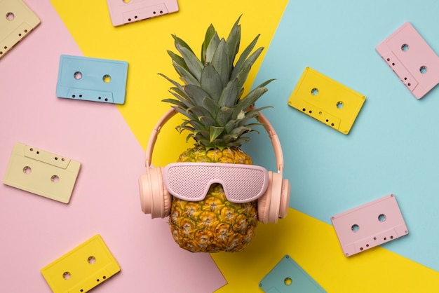 View of pineapple fruit with cool sunglasses and headphones