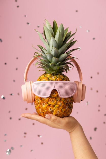 View of pineapple fruit with cool sunglasses and headphones
