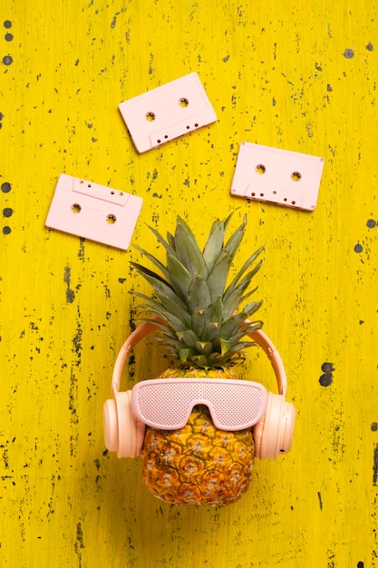 View of pineapple fruit with cool sunglasses and headphones