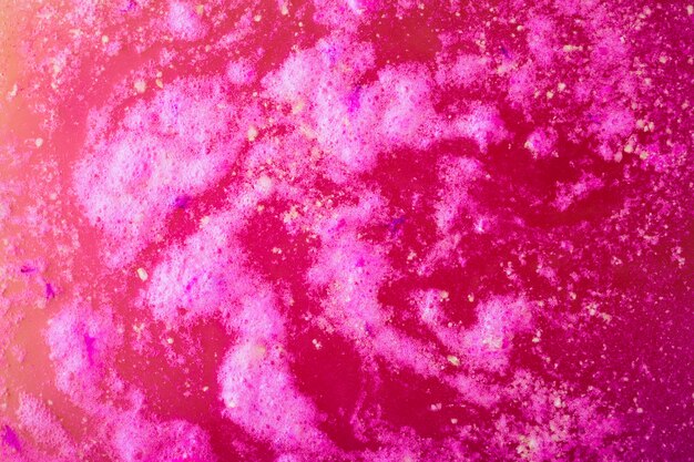 View of pink foam after dissolving color bath bomb in water