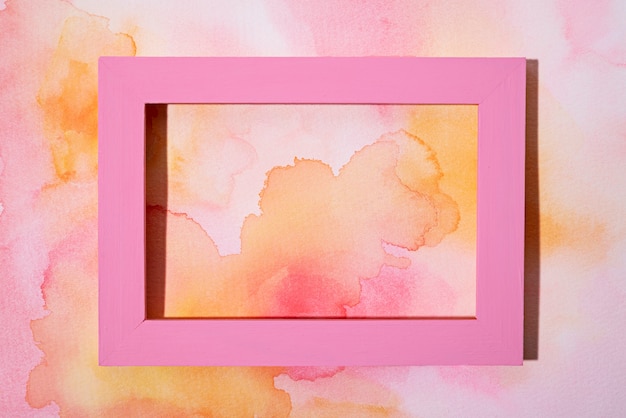 Above view pink frame on hand painted background