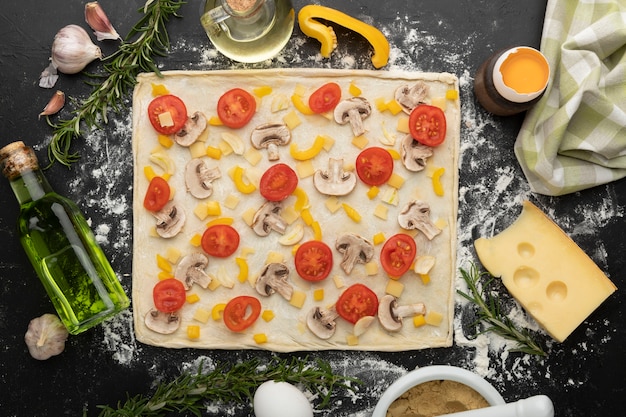 Free photo above view pizza dough with tomatoes