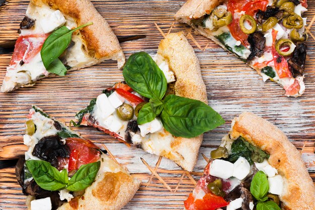 Above view pizza slices on cutting board