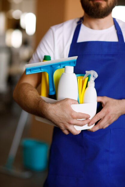 View of professional cleaning service person holding supplies