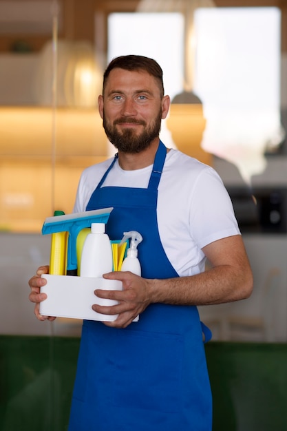 View of professional cleaning service person holding supplies