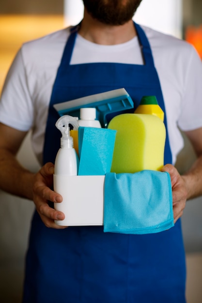 Free photo view of professional cleaning service person holding supplies