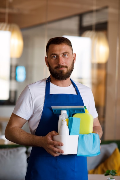 View of professional cleaning service person holding supplies