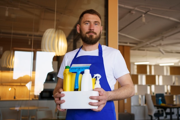 View of professional cleaning service person holding supplies