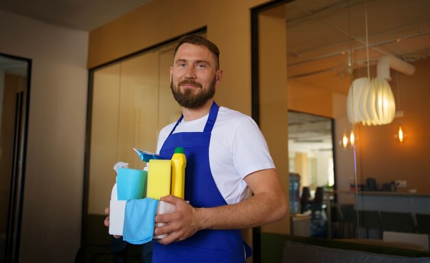 View of professional cleaning service person holding supplies