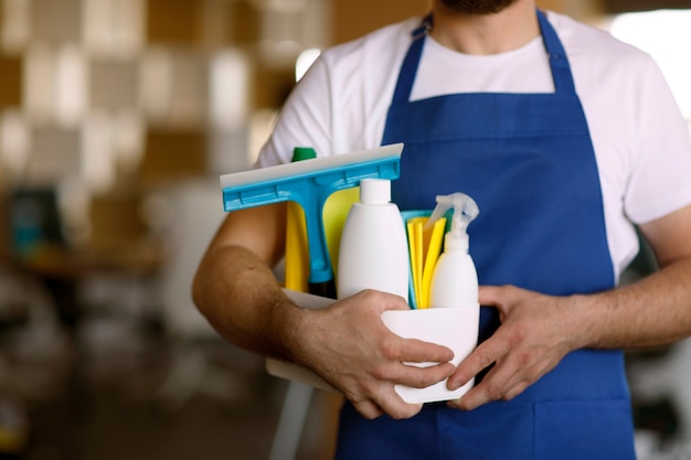 Free photo view of professional cleaning service person holding supplies