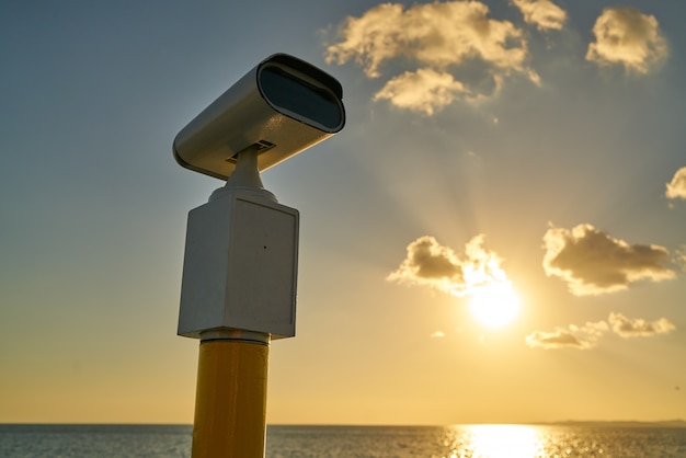 View of public binoculars at sunset